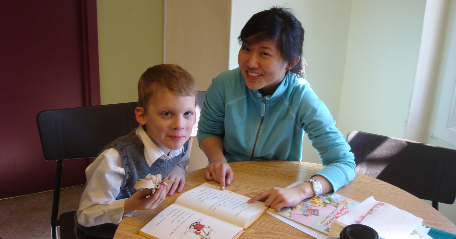 A student tutoring a child at an afterschool club A student tutoring a child at an afterschool club