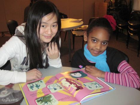 Student reading with a child at an afterschool program A student reading with a child at an afterschool program