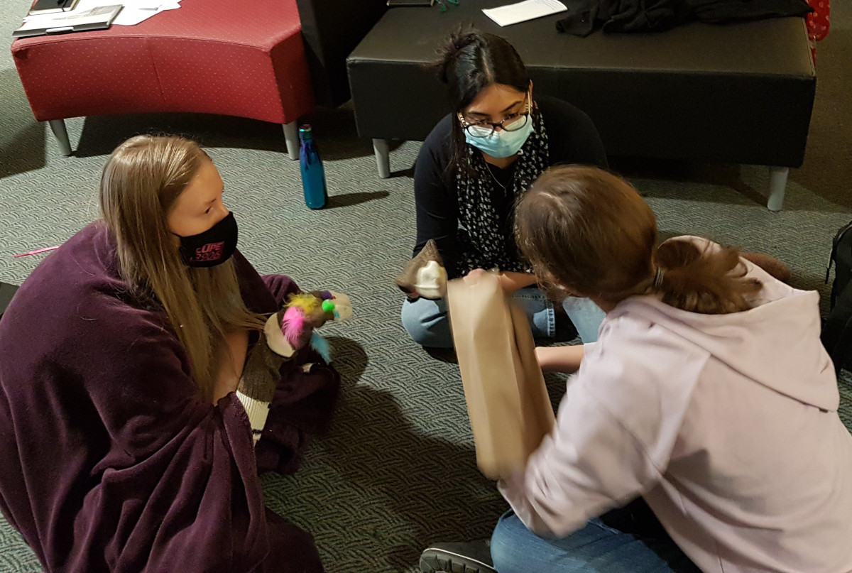 Playing with sock puppets at the Open Circle retreat Students play with sock puppets at an Open Circle retreat